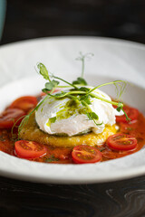 Portion of gourmet italian breakfast with mozzarella tomatoes and poached egg