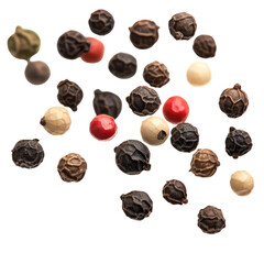 A close up shot of a variety of peppercorns including black white green and pink on a black background