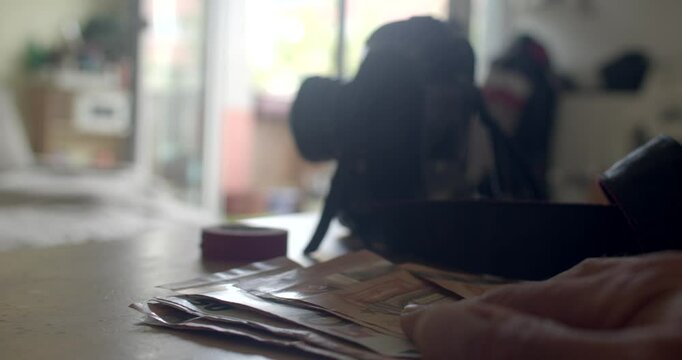 A detailed closeup shot of scattered papers and a camera in a creative workspace, perfect for artistic inspiration