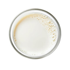 A top down view of a clear glass filled with a white liquid and small bubbles around the edges of the glass