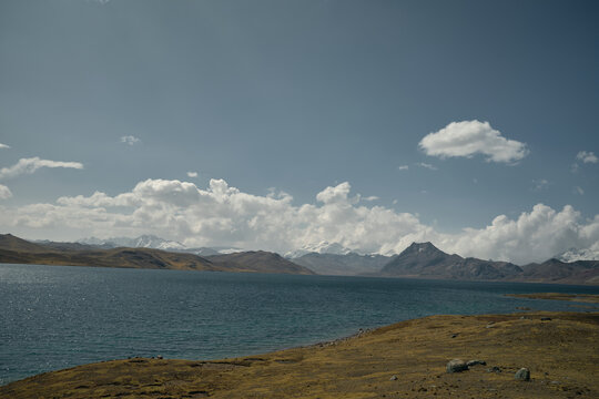 Blue lake with mountain range background - Powered by Adobe
