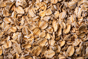 Textured oatmeal grains on white background