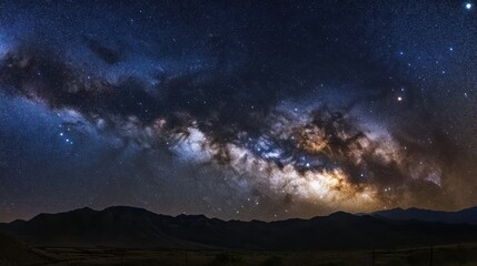 Naklejka premium Stunning view of the Milky Way over mountains, a beautiful cosmic landscape.