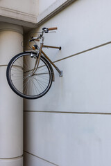 Front part of a bicycle mounted to an outside wall