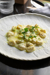 Portion of gourmet italian potato gnocchi with creamy sauce