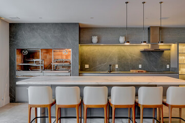 Bright Modern Kitchen with Marble Island and Pendant Lighting