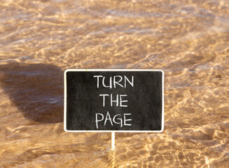 Naklejka premium Turn the page symbol. Concept words Turn the page on beautiful blackboard. Beautiful Red sea water background. Business motivational lifestyle turn the page concept. Copy space.
