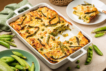 Spring Vegetable Lasagna - Lasagne primavera, with asparagus, peas, zucchini and aged ricotta cheese. Homemade baked italian food.