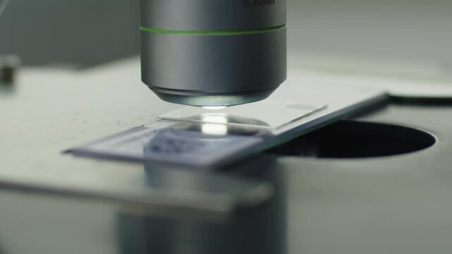 A scientist works with a microscope in the laboratory. Conducts research of biomaterial samples.