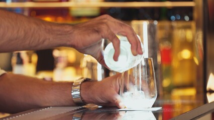Closeup bartender hand in poring fresh soda gas texture into glass of drink advertisement serving customer at beverage bar counter luxury pub for welcome impression greeting guess service. Vinosity.