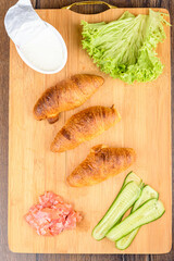 Top view of freshly baked croissants and filling ingredients.