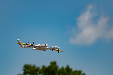 Close up of a drone in flight isolated against a blue sky with copy space