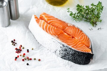 pieces of fresh raw salmon steak on the table with thyme and olive oil. recipe preparation
