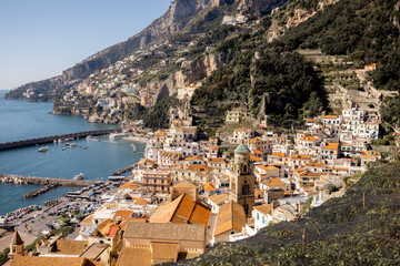 A breathtaking aerial view of Amalfi town stretching along the cliffs and sea. This image represents Mediterranean charm, coastal living, and ideal visuals for travel, real estate, or luxury brands