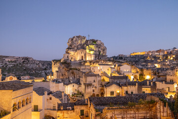 The ancient cave dwellings of Matera glow under soft evening light. This photo captures timeless architecture, mystique, and cultural heritage ideal for travel, history, or cinematic concepts