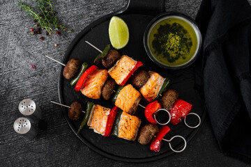 salmon skewers with vegetables and green sauce. summer barbecue recipe