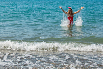Tropical Santa Soiree: Girl in Red Swimsuit and Santa Hat Dive