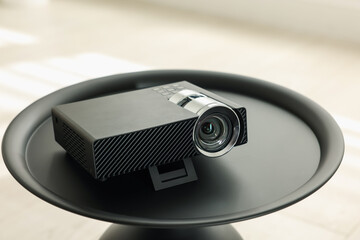 Modern video projector on black table indoors