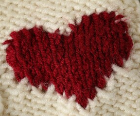 Texture of beige wool fabric with heart as background, top view