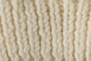 Texture of beige wool fabric as background, closeup