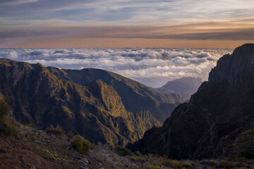 Breathtaking view from Pico do Arieiro in Madeira, showcasing mountains above a sea of clouds during sunset