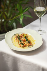 Portion of gourmet grilled shrimp skewers with wine