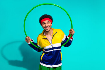 Retro-styled young athlete with hula hoop against a vibrant teal background, showcasing sports...