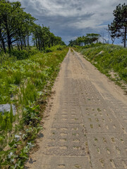 A concrete road laid on a sandy area