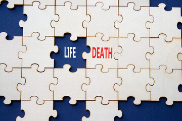 Fototapeta premium Life or Death symbol. Concept word Life or Death on wooden puzzle. Beautiful deep blue background. Business and Life or Death concept. Copy space
