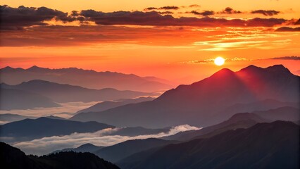 Obraz premium Fiery Sunset Over Layered Mountains with Clouds and Silhouettes