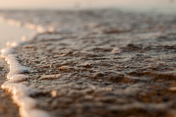 close-up of sand, shells and the sea