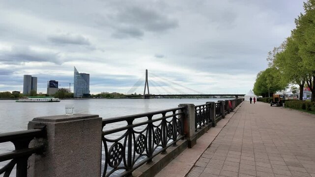 Scenic view of the Vansu Bridge on Daugava river under cloudy sky