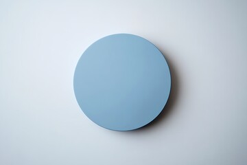 A simple light-blue circle placed on a plain, light-gray surface, creating a minimalistic and clean design