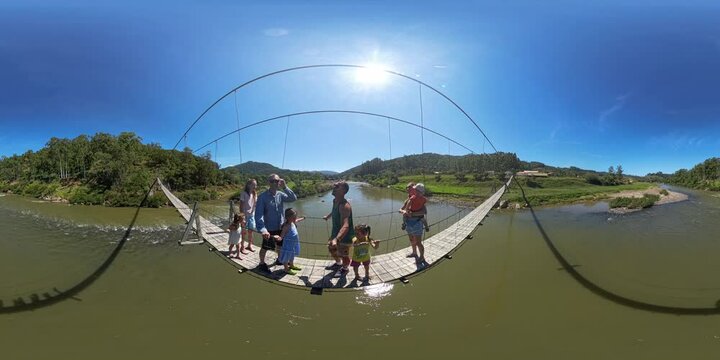 360 VR panorama of people walking on a hanging bridge over the rapid river in Brazil
