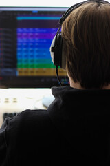 Man at a computer screen with audio tracks on it. A man at a computer processes audio tracks....