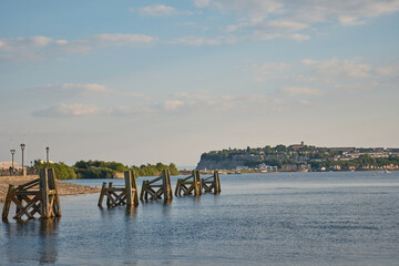 Fototapeta premium Cardiff Bay. Wooden structures known as Dolphins which were used as moorings for boats. The barrage and Penarth in the distance.