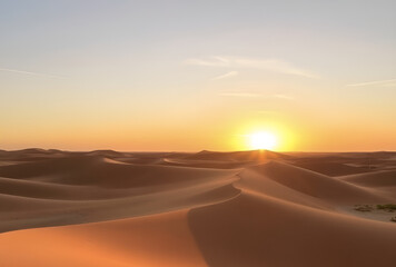 Warm hues of sunrise and sunset paint the vast desert landscape, with golden sand dunes stretching towards an arid sky, inviting summer adventure, Generative AI