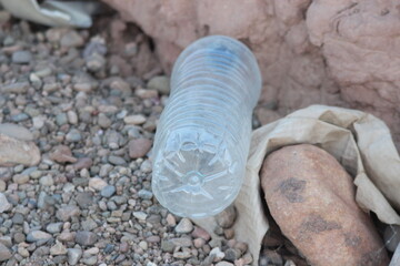 A plastic bottle lying on the ground, Environmental pollution	