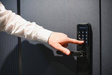 Businessman opening door using digital code panel security system