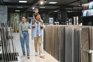 Family choosing ceramic tiles in a modern plumbing store