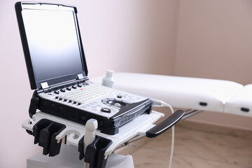 Modern ultrasound machine and examination bed in clinic