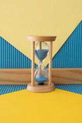 Hourglass with a flowing blue sand inside	