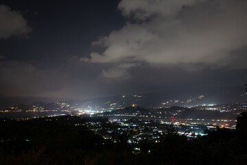 Ko Samui at night, Image shows sunset over the small island from the top of a mountain overlooking the airport, runway  and nearby town 
