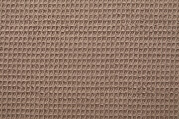 Clean brown waffle towel as background, top view
