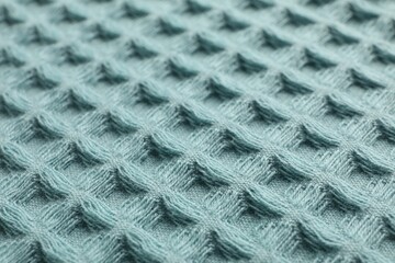 Clean light blue waffle towel as background, closeup