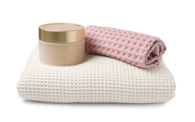 Clean waffle towels and cosmetic product isolated on white