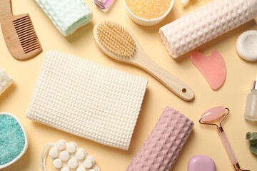 Clean waffle towels, cosmetic products and supplies on beige background, flat lay
