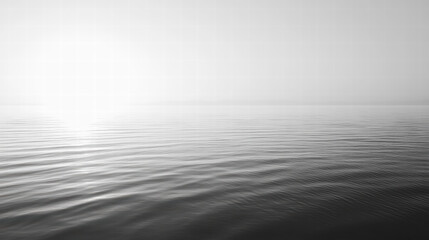 Serene Seascape: A captivating monochrome image captures the tranquil vastness of the open sea, with its gentle waves, and ethereal mist at the horizon, inducing a sense of calm and wonder.