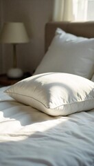 Soft, fluffy pillow resting on a crisp white bedsheet, ready for a peaceful night's sleep Sunlight gently illuminates the scene, highlighting the texture and comfort , comfort, memory foam, cotton