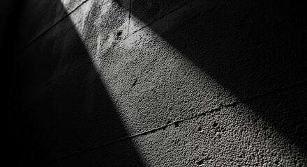 Textured wall with diagonal light and shadow